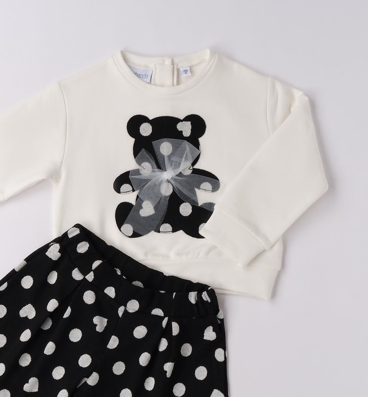 Girls black spotty shorts and ivory sweater with black sporty teddy bear detail
