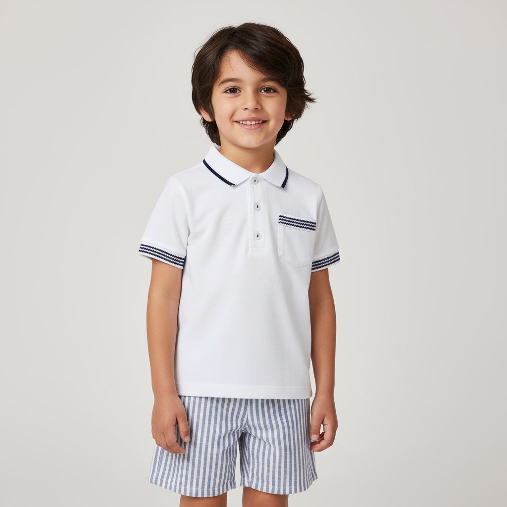 Child wearing a white polo shirt with black trim and striped shorts on a light gray background