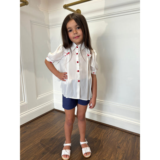 Girls white blouse with red love heart pattern and navy shorts by Piccola Speranza - Adora Childrenswear 