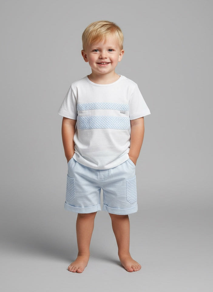 Young boy wearing a white t-shirt with blue stripes and light blue shorts on a gray background